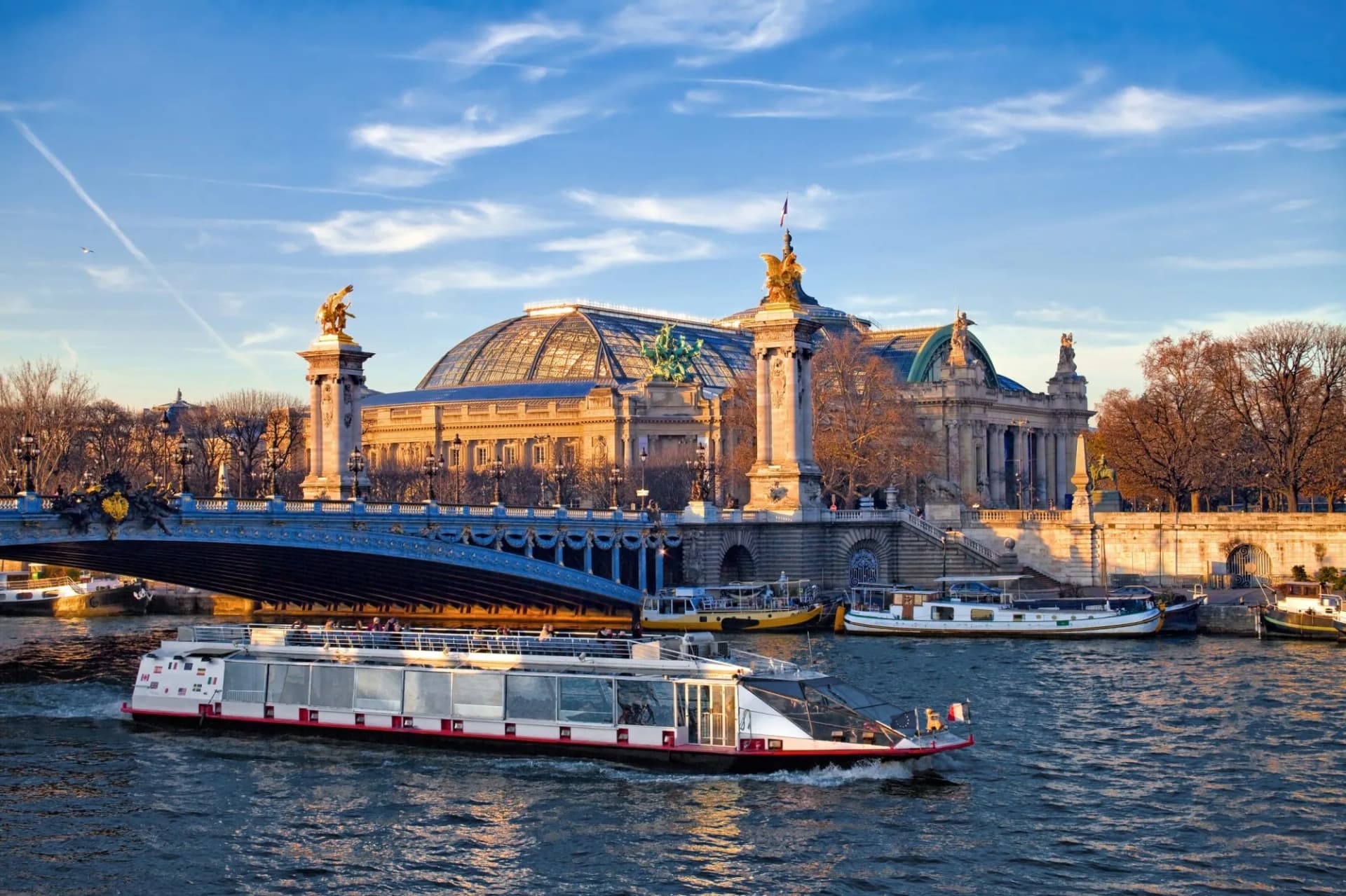Tour boat cruising the Seine River past the Grand Palais in Paris.