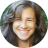 Smiling woman with brown hair in circular portrait